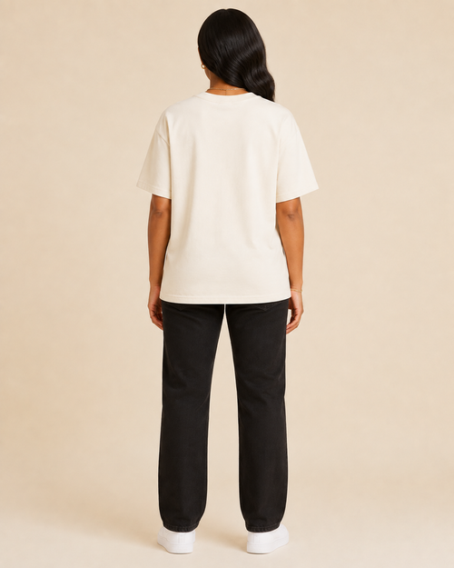 Black woman modeling Follow Jesus Tee back view