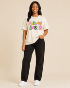 Black woman modeling Follow Jesus Tee front view